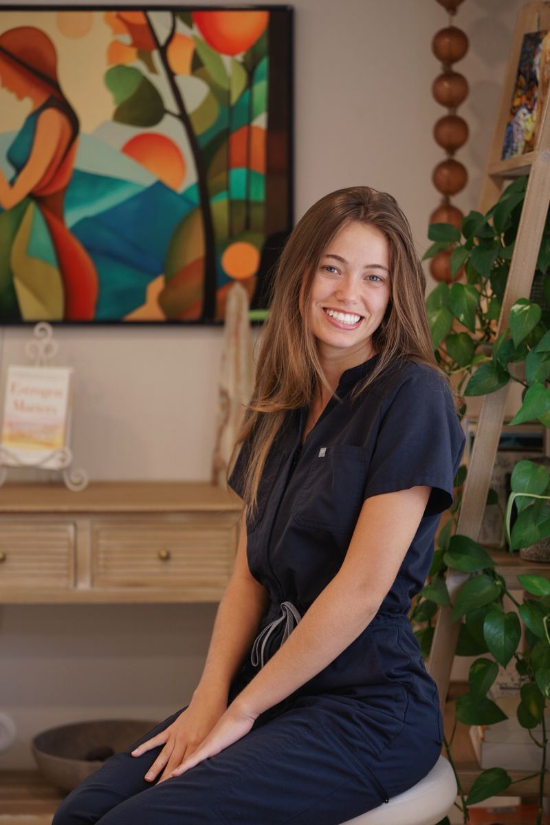 Summer, Dori Imaging’s sonographer, smiling in navy scrubs